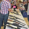 A table of guns on display.