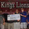 Kings Lions Ray Etchegoin and President Jeff Garcia present a check for $2,000 to members of Naval Aviator Memorial group.