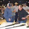 Bill Schuh checks out a gun at the Friends of the NRA dinner Saturday night.