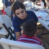 An FFA student paints a youngsters face.