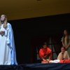 Mary (Ashley Eller) with Helen and her daughters looking on.