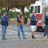 Firemen help hold the lights while the tree is placed.