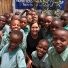 Janet Brown surrounded by Third Grade students at the Kenyan Community Center she visited in September, during which she and others delivered sports equipment.