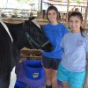 Kaitlin and Kristina Raulino with their cow.