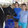 Kaitlin and Kristina Raulino with their cow.