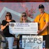 Kristine Rhoads and Shannon Jacobs accept a check from Lions President Adam Vonder Ahe-Cossey for Sober Grad.