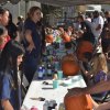 The pumpkin painting tables are full.