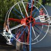 Rich Shimmon, behind wheel, uses a little elbow grease to get the Ferris wheel turning.