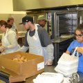More volunteers on the meal assembly line.