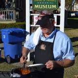 Bill Black helps cook chili dogs at the Mooney Museum.