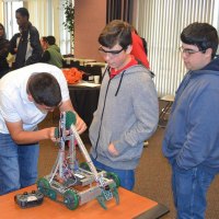 Conor Shortnacy, Phillip Augusto and Anthony Augusto prepare their robot.
