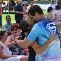 Under hypnosis, this man gives his wife a big kiss.