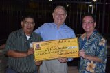 Tachi Hotel General Manager Willie Barrios and Class of 1978 President George Will present Bill Black with a $500 check.