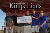 Kings Lions Ray Etchegoin and President Jeff Garcia present a check for $2,000 to members of Naval Aviator Memorial group.