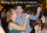 Lemoore's Brett and Katie Mitchell sample one of several wines offered at the annual Evening Under the Stars Saturday night in downtown Lemoore.