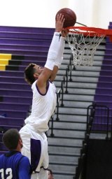 C.J. Johnson goes for the dunk against Hanford West