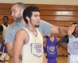 Coach Joel  Sligh gives CJ Johnson some pointers during practice.