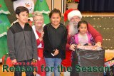 These youngsters got an early Christmas, left to right Israel Torres and sisters Precious and Envy. Santa and Ms. Claus were on hand to help distribute the presents.