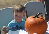 This youngster, Henry, picked out a plump pumpkin and begins to apply a myriad of colors.