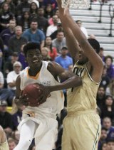 Jaylunn English had 22 points in Wednesday night playoff loss to Long Beach Poly. Here he's going up against Poly's Zafir Williams.