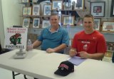 Matt Cole at his signing on Thursday with father Charles.