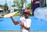 Louis Cuyno gets in the mood as he twirls pizza at 2015 Pizza Festival.