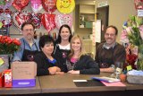 Proud of their new location: Owners Chris Brazil (far left) and John Miller (far right) join employees (left to right) Cathy Morse, Samie Souza and Stacie Holmes in the new Ramblin' Rose.