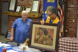 Lions Club President Ray Etchegoin accepts gift from outgoing "Guiding Lions" Bill and Carrie Diltz.