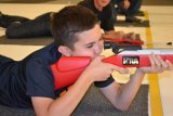 Lemoore High School's Jack Wolstenholme takes aim at the city's new air rifle range Monday night.