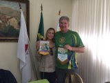 Dwight Miller trades Rotary flags with President Denise of the Belo Horizonte club during their World Cup trip through Brazil.
