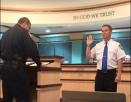 John Ecker is sworn in as the newest police chaplain by Chief Darrel Smith.