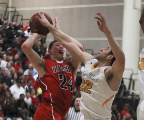 Matt Borba attempts to block a Ryan Johnson shot during Lemoore's 71-67 win over Hanford in the Division II playoffs.