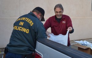 Christian Aid and Lemoore police come together to assist families with food and gifts Lemoore Chistian Aid Director John Benton and Brian Monical help pack chickens.