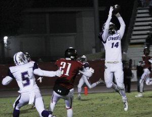 Tigers earn West Yosemite League title and Milk Can for second year in a row AJ Bow goes high while Reggie Davis looks on.