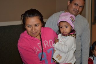 Christian Aid and Lemoore police come together to assist families with food and gifts Two-year-old Naomi Garcia and family.