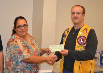 The Lemoore Police Department's Soledad Perez received a check for Reason for the Season from the Lemoore Lions.