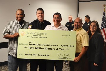 Left to right: Councilmember Eddie Neal, Chief Darrel Smith, Assemblymember Rudy Salas, Councilmember Ray Madrigal and City Manager Andi Welsh pose with a $5 million check presented to the cities of Avenal, Corcoran and Lemoore.