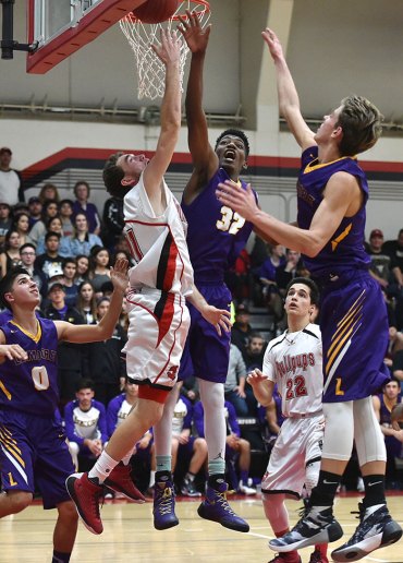 Jaylunn English and Spencer Stinger battle for the ball. English had 21 points for the Tigers. Stinger scored 8 as Lemoore beat the Bullpups 55-50.