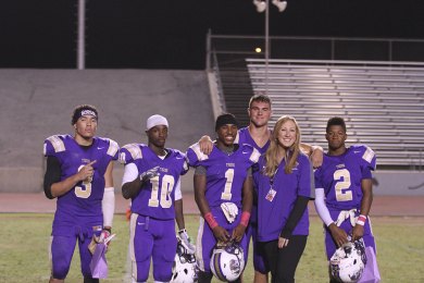 Megan Sula Rix is nearly always on the sidelines, this time with players, left to right: Darnell Foster, Roger Wilson, Marquise Love, Zac Frazier, and Reggie Davis.
