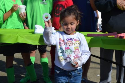 Three-year-old Isabel Quintero enjoys the ring toss.