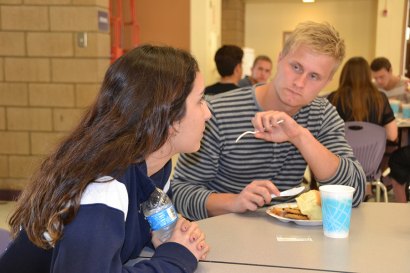 Mads Nielsen, 19, enjoys lunch and a chat with Lemoore High School Future Farmers of America Treasurer Madison Guzman.