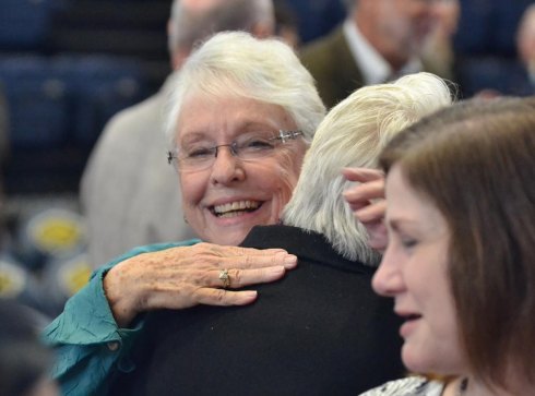 Lynn Sedgwick embraces friends following an inspirational memorial service held Saturday in the West Hills College Golden Eagle Arena to honor her late husband, Gary Sedgwick.