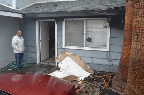 A friend of Michael Patrick surveys the damage Tuesday morning.