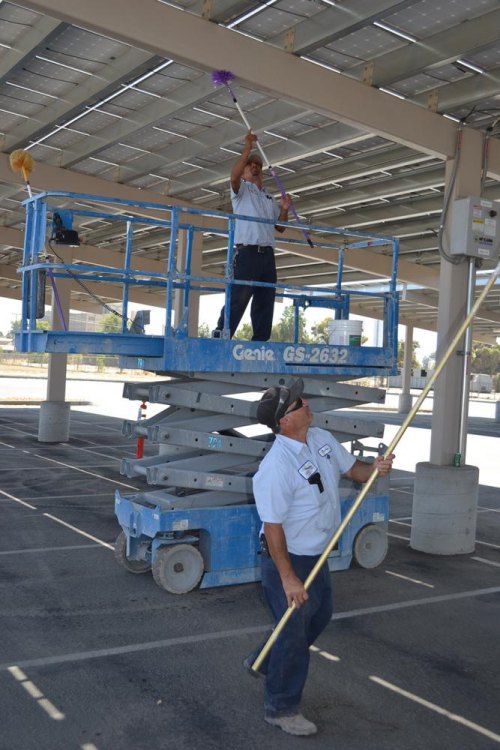 Reben Reyna (below) and Oscar Coronado work on the solar panels at the Public Works Department.