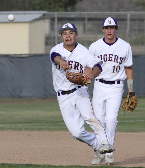 Lemoore's infielder Russ Tuman gets an out against Hanford West in the WYL opener. A.J. Bow watches in the background.