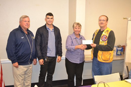 Lemoore Lions presented WHC Lemoore officials, including President Don Warkentin and Frances Squire, with checks. Lions President Adam Vonder Ahe-Cossey presented the checks. John Michael Toste (second from left) also received a scholarship.