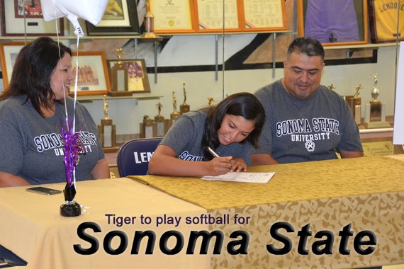 Megan Ambriz signs letter-of-intent to play softball for Sonoma State as mom Joanna and father Armando look on.