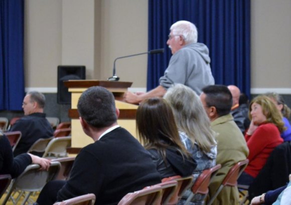 A concerned Lemoore resident and golfer asks a question during study session on golf course.