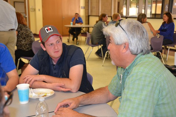Emil Gar Ger Williamsen, a Denmark agricultural student, currently on a tour of California's ag industry, chats with Kings County Supervisor Craig Pedersen in the Lemoore High cafeteria.