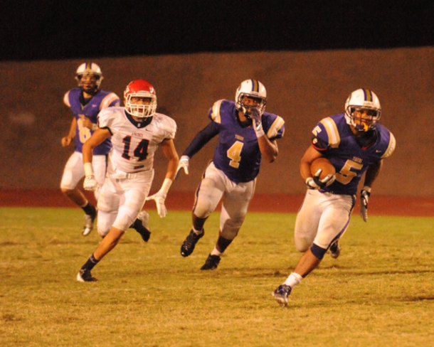 Richard Doctor runs for a score in football action this past season. Leading the charge is Rashaun Davis (no. 4).